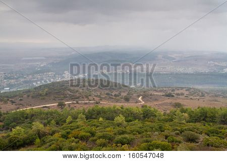 View of the Jezreel Valley in fog in winter cloudy day from Muhraqa on Mount Carmel in Lower Galilee Israel
