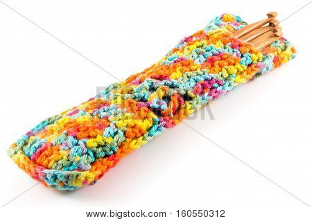 Wooden crochet hooks in crochet bag isolated on white background