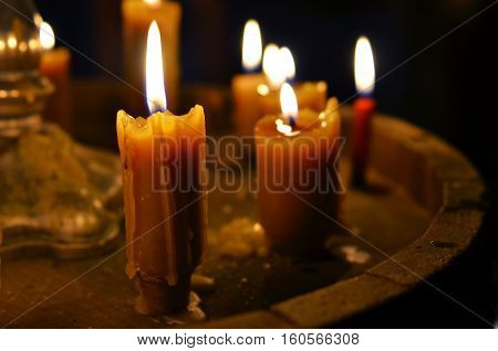 Antique candle burning in a dark room. Christmas Eve divination yuletide. Christmas backgrounds. holiday rituals religion spirituality zen.