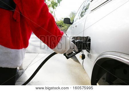 Santa Claus Gas Station Fill up. Santa refuels his truck before Christmas eve. 