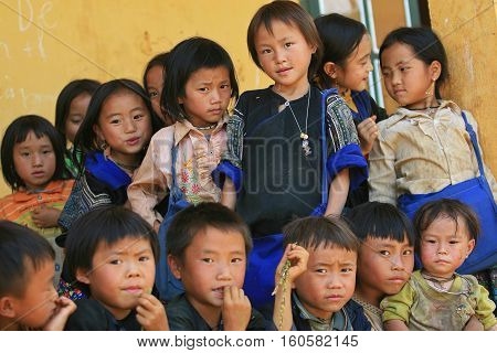 MU CANG CHAI, VIETNAM - SEP 20, 2010: Unidentified Vietnamese minority children looking at the visitor's camera at the play ground of their school.