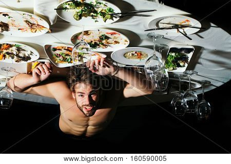 Handsome Man Lying Under Table