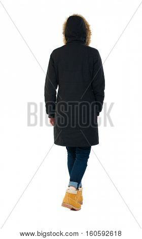 Back view of going  woman in parka. walking young girl. Rear view people collection.  backside view of person.  Isolated over white background. Wearing a hood on his head girl goes away.