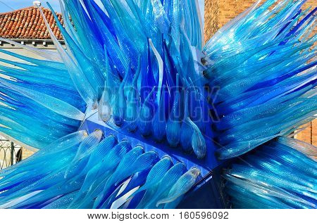 MURANO - SEP 22 2014: Modern installation of Murano glass on the street of famous Murano island Venice. Landmark of Veneto region Italy