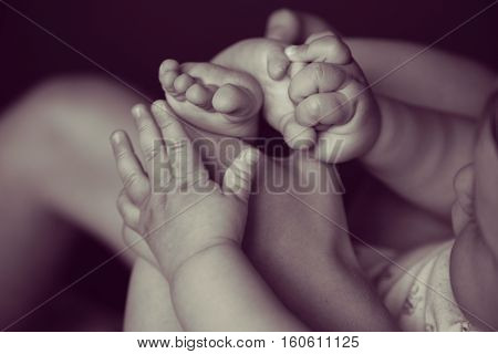 The baby plays with the small legs. Little baby