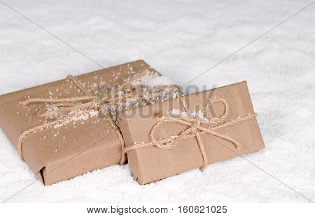 Christmas gifts on a white snow New year