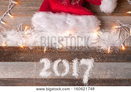 Happy New Year 2017 holiday. Christmas decoration. Santa hat and gifts.
