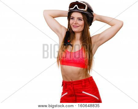 Sensual attractive femine winter sport concept. Woman wearing alluring ski suit and helmet with goggles