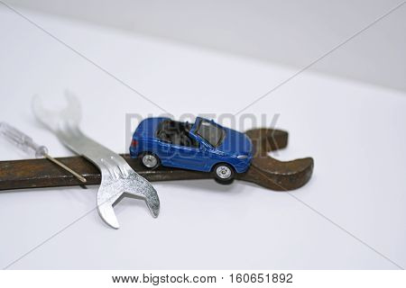 Abstract composition of broken car and repair process.