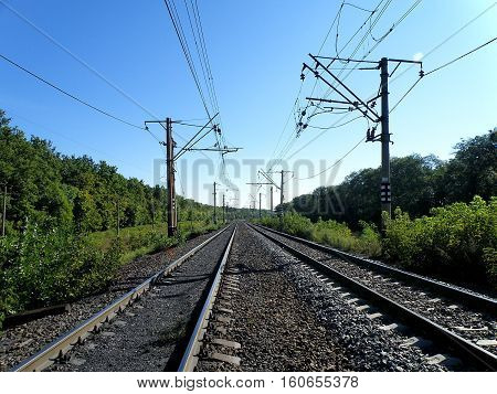 Double-track electrified railroad goes into the distance.