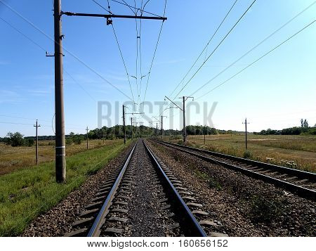 Double-track electrified railroad goes into the distance