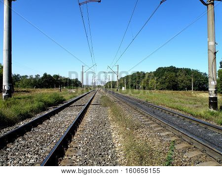 Double-track electrified railroad goes into the distance.