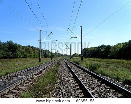 Double-track electrified railroad goes into the distance.