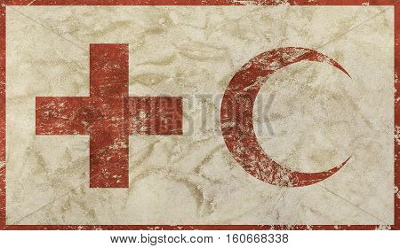 Old grunge dirty background with vintage faded shabby distressed flag of international non-governmental humanitarian organization