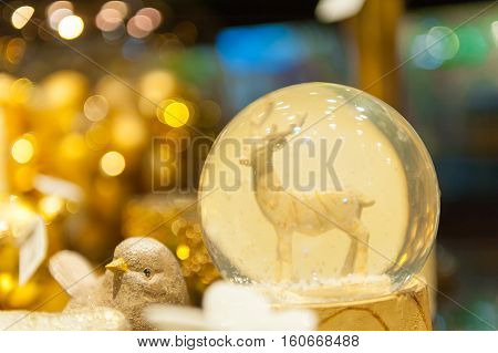 Christmas snow globe with an deer in snow inside of spere