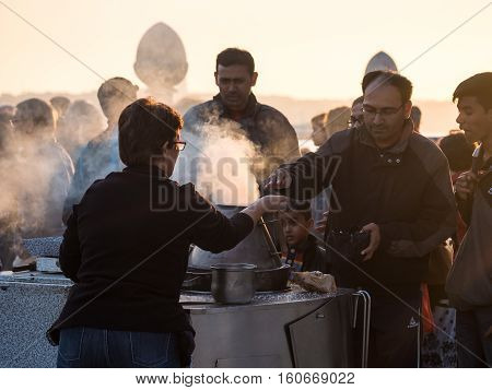 LISBON PORTUGAL - NOVEMBER 17 2016: Woman selling roasted chestnuts in Cais das Colunas in Lisbon Portugal.