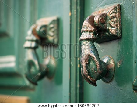 Old hand shaped metal door handles in Bairro Alto Lisbon Portugal