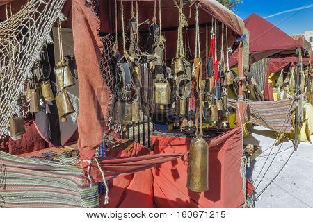 outdoor scene with a cowbells shop in the recreation of a medieval market. the market have free admission and is located on a public place