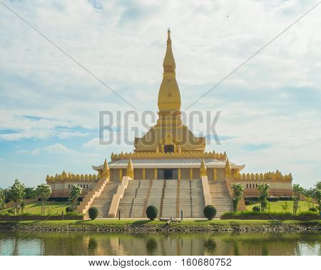 Gold Pagoda on blue sky background Roiet Thailand