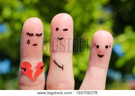 Finger art of people. Man flirts with woman. Other girl is holding broken heart. Concept of cheating in relationship.