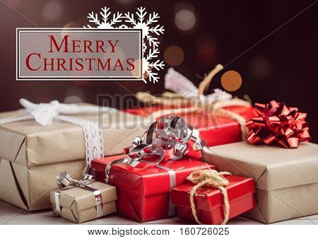 Merry christmas message against red and brown christmas gift boxes