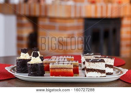 Assortment of different sweet cream cakes on plate