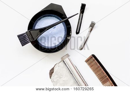 Tools for hair dye and hairdye top view on white background