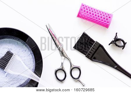Tools for hair dye and hairdye top view on white background