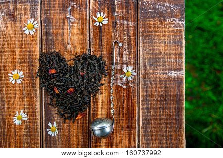 Vintage Strainer Near Dry Leaves Of Black Tea Make In Heart On Wooden Table In Garden And  Nature Ba