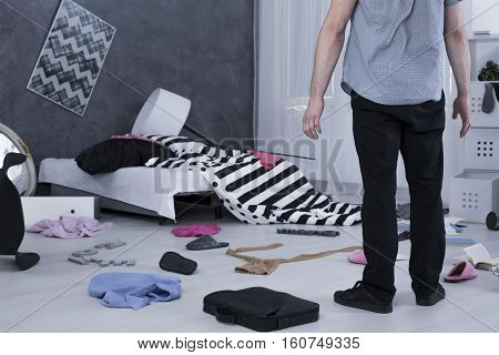 Surprised Man In Messy Room