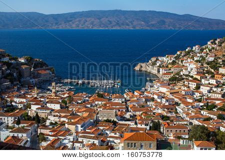 Top view on houses and yachts marina at Hydra island, Greece, Aegean sea.