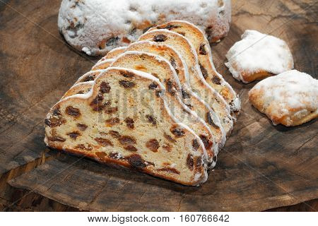 Christmas stollen with Christmas decoration on a wooden plate