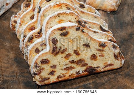 Christmas stollen with Christmas decoration on a wooden plate