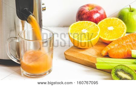 process of preparation of fresh juice in juicer close up