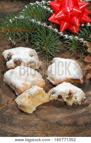 Christmas stollen with Christmas decoration on a wooden plate