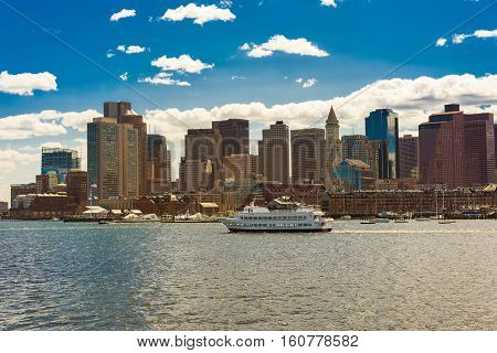 Boston Skyline And Ship Floating Across The River