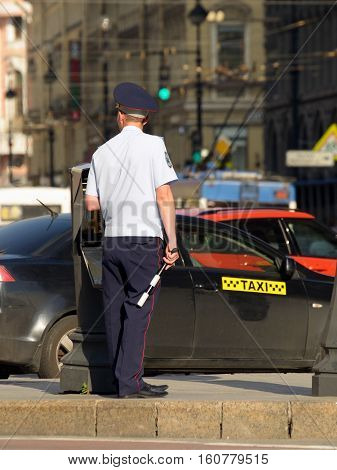 30.06.2016.Russia.Saint-Petersburg.Policeman regulates the movement of vehicles in the city.
