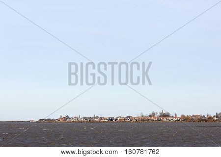 former island of Marken behind markermeer in the netherlands on sunny day