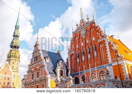 View on the central square with famous houses of Blackheads and cathedral tower in Riga city, Latvia