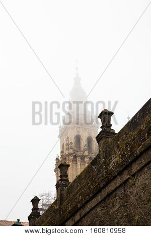 View of the belltower of the Santiago cathedral covered by fog Spain