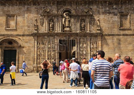 SANTIAGO SPAIN - AUGUST 16: Pilgrimns of the way of St. James waiting at the entrance of the cathedral on August 16 2016