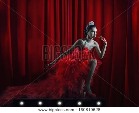 girl in a red dress and a crown on the stage