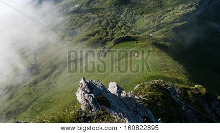 The ridge of a mountain with clouds rushing by