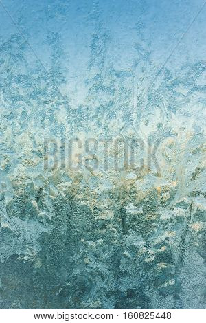 frost and ice patterns on windowglass coverd with ice