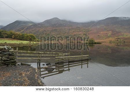 Beautiful Autumn Fall Landscape Image Of Crummock Water At Sunrise In Lake District England