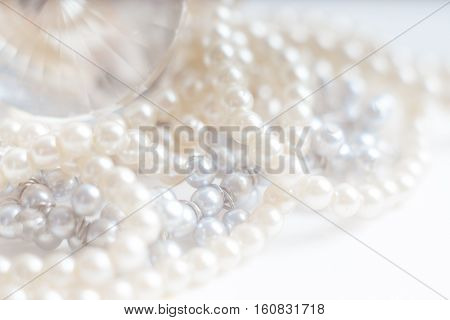 Abstract blurred background pearl necklace on white. Macro shot Shallow depth of field defocused