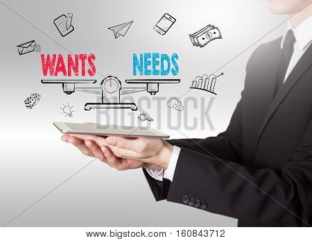 Wants and Needs Balance, young man holding a tablet computer