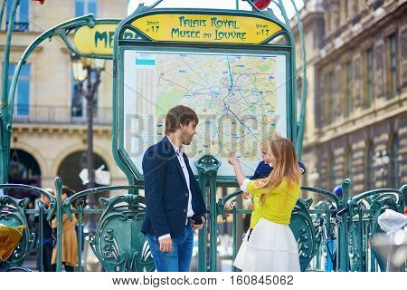 Family Of Three In Paris, Looking At Parisian Subway Map