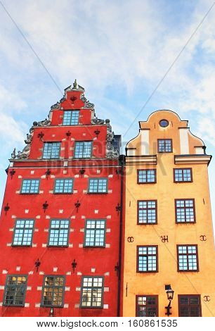 Red and Yellow iconic buildings on Stortorget - a small public square in Gamla Stan, the old town in central Stockholm, Sweden