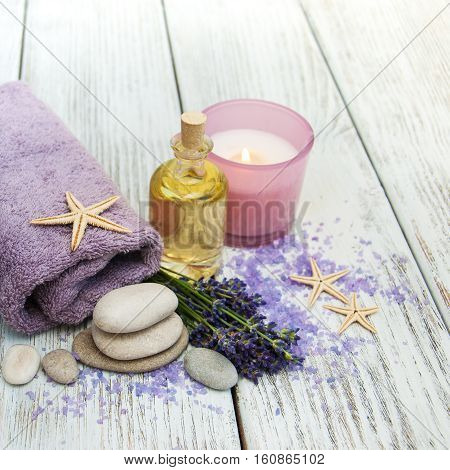 Lavender with essencial oil on a wooden table